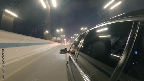 Hyperlapse car driving on the street in Dubai city at night. Side car view driving in Dubai UAE at night photo