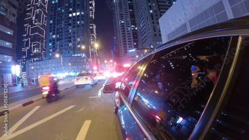Hyperlapse car driving on the street in Dubai city at night. Side car view driving in Dubai UAE at night photo