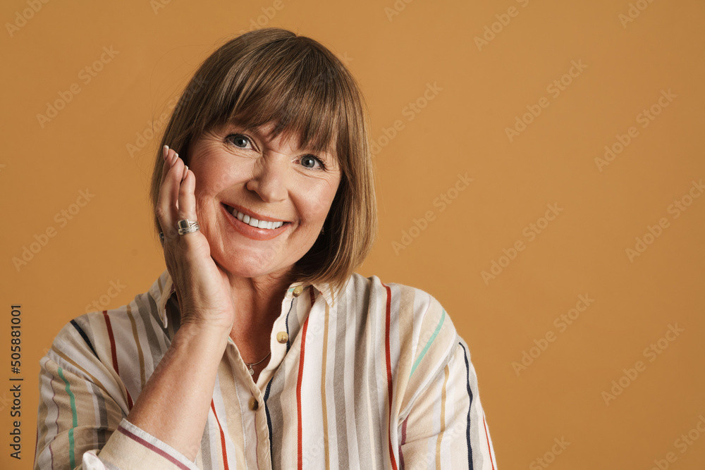 White mature woman wearing shirt smiling and looking at camera White mature woman wearing shirt smiling and looking at camera