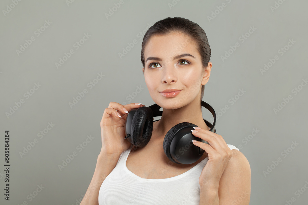 Fototapeta premium Happy pretty brunette woman with headphones portrait