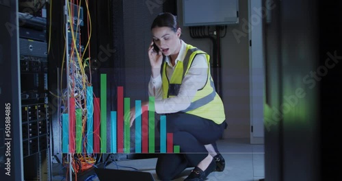 Animation of graphs over caucasisn woman working in server room photo