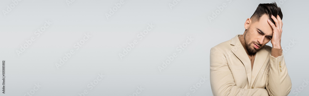 frustrated critic touching bowed head isolated on grey, banner. frustrated critic touching bowed head isolated on grey, banner.