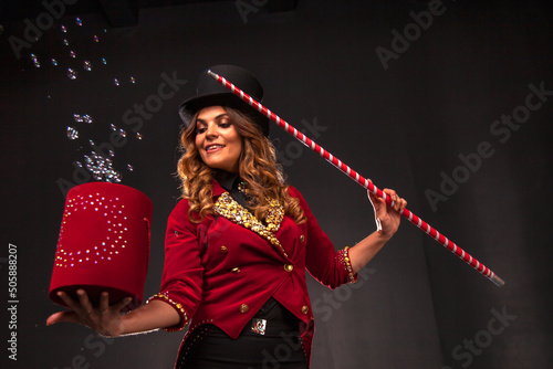 Female magician makes with soap bubbles show, an illusionist