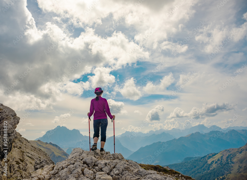 Sporty Young woman on mountain trail Dolomites Mountains, Italy