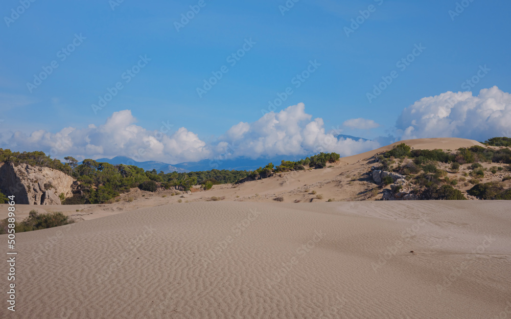 Patara beach is famous tourist landmark and natural destination in Turkey. Majestic view of orange sand dunes and hills glows