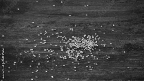 Silica gel balls  scattered on black wooden background that are used in new products to prevent moisture.  