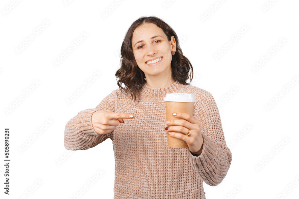 Cheerful woman is pointing at a take away paper cup she is holding. Studio shot over white background. Cheerful woman is pointing at a take away paper cup she is holding. Studio shot over white background.
