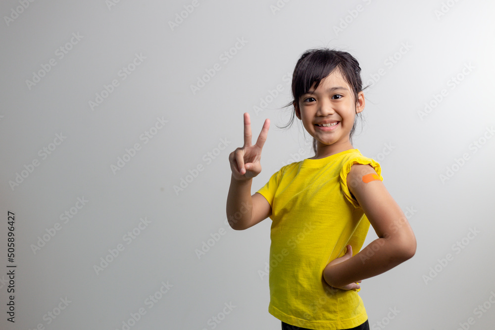 COVID 19 Vaccines for Kids concept. Studio a portrait of an adorable Asian girl after getting his first dose of vaccine. Immune, Safe, Available, Back to school. COVID 19 Vaccines for Kids concept. Studio a portrait of an adorable Asian girl after getting his first dose of vaccine. Immune, Safe, Available, Back to school.