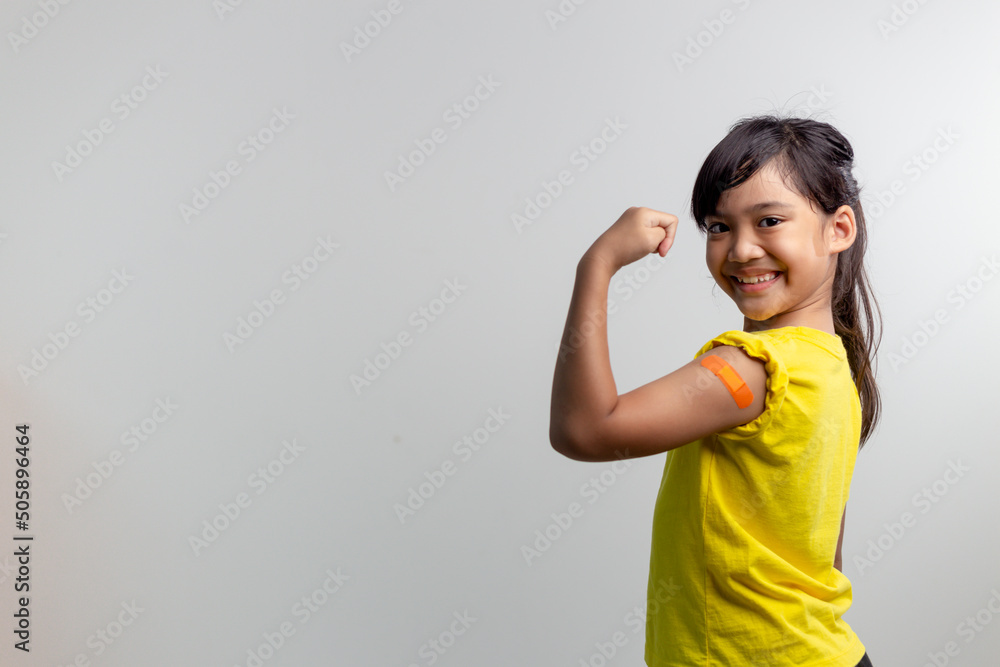 COVID 19 Vaccines for Kids concept. Studio a portrait of an adorable Asian girl after getting his first dose of vaccine. Immune, Safe, Available, Back to school. COVID 19 Vaccines for Kids concept. Studio a portrait of an adorable Asian girl after getting his first dose of vaccine. Immune, Safe, Available, Back to school.