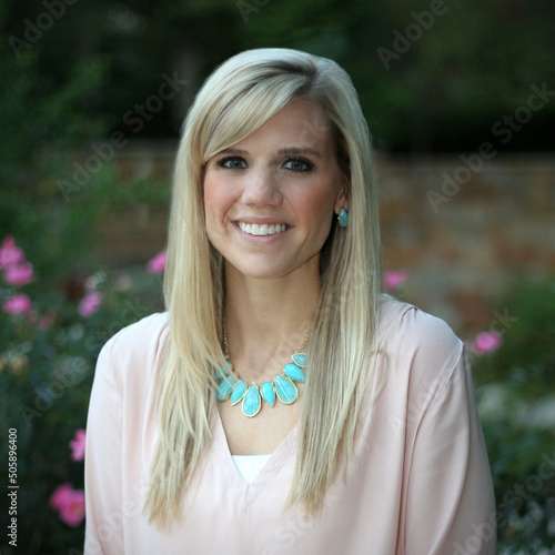 Young woman portrait dressed in pastels with a garden background