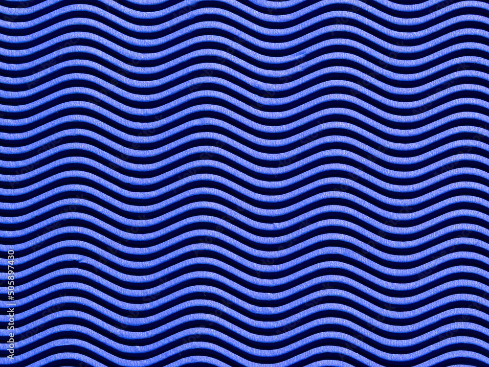 The Background Is Made Of Corrugated Wavy Cardboard in blue. The Texture Of Horizontal Waves Of Blue Paper. Relief waves on Paper background The Background Is Made Of Corrugated Wavy Cardboard in blue. The Texture Of Horizontal Waves Of Blue Paper. Relief waves on Paper background