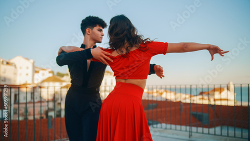 Beautiful Couple Dancing a Latin Dance Outside the City with Old Town in the Background. Sensual Dance by Two Professional Dancers on a Sunset in Ancient Culturally Rich Tourist Location.