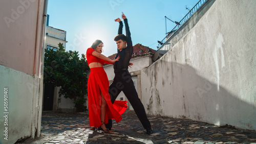 Beautiful Couple Dancing a Latin Dance on the Quiet Street of an Old Town in a City. Sensual Dance by Two Professional Dancers on a Sunny Day Outside in Ancient Culturally Rich Tourist Location. © Gorodenkoff