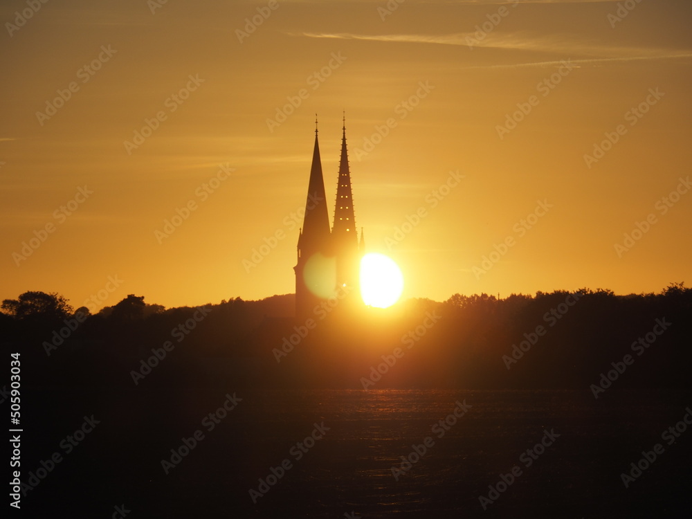 Sunset behind the Douvres-la-Délivrande church in Normandy, France