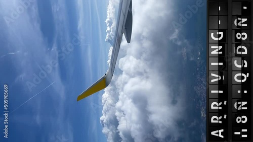 view of the sky from an airplane and a display board with arriving in Las Vegas, vertical video in 9-16
