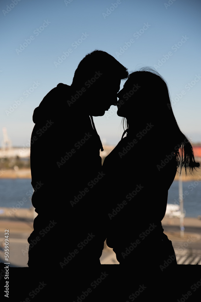 man and woman are hugging. silhouette