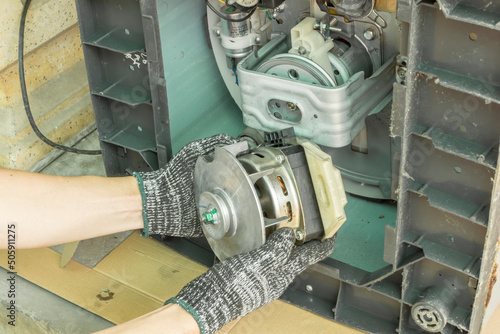 Technician remove motor washing machine, Checking washing machine motor, Home appliances repair service.
