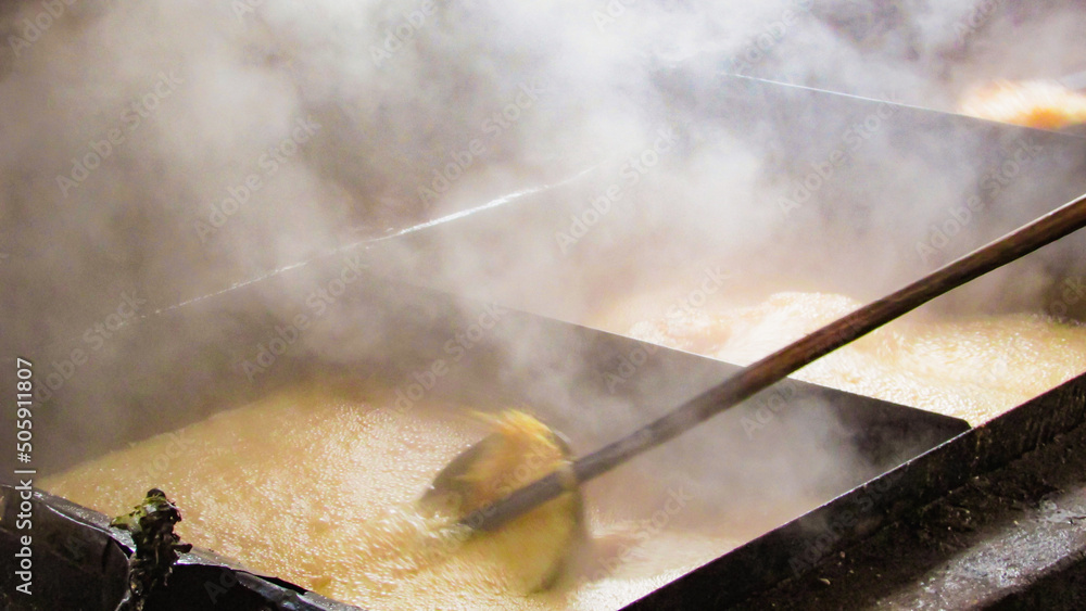Φωτογραφία large tacho of boiling molasses the main ingredient of the rapadura, the molasse