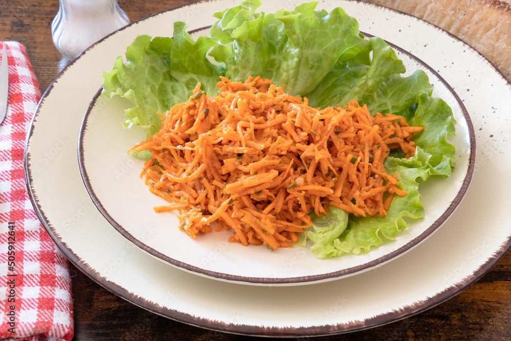 grated carrot on a plate with salad grated carrot on a plate with salad