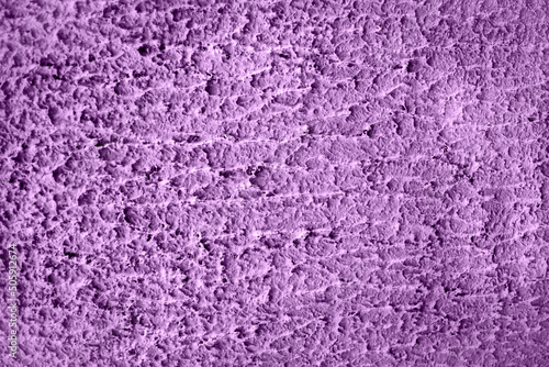 Concrete lilac wall background on the street.