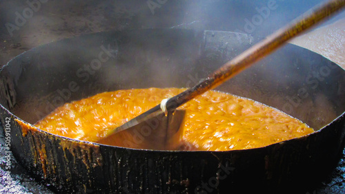 large tacho of boiling molasses the main ingredient of the rapadura, the molasses effervido and mechido trasnferido in variso pachas during the process