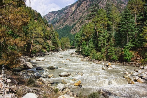 Mountain with turbulent river. Chalal Trek in Kasol, Himachal Pradesh, India photo