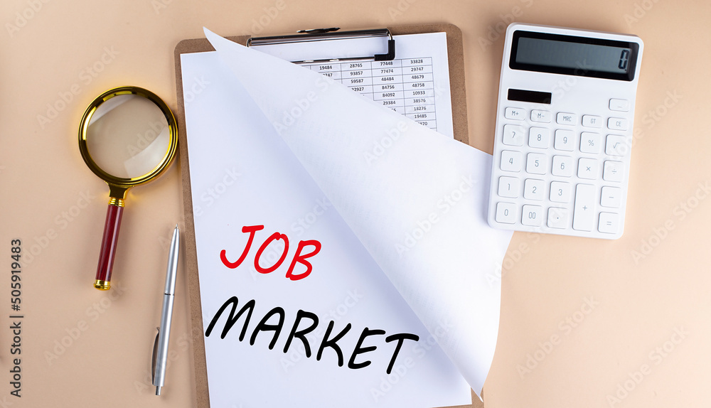 Clipboard with chart and text JOB MARKET with magnifier ,calculator on beige background Clipboard with chart and text JOB MARKET with magnifier ,calculator on beige background