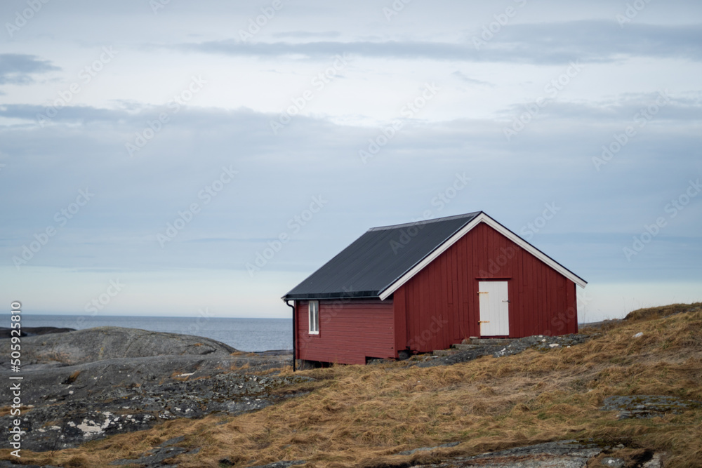 solitaire seafron traditional red house in norway located in Bud, Norway 