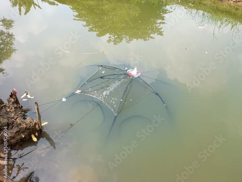 Fotografi fishing net in river water seen from above