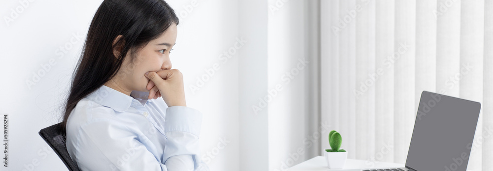 Asian woman is studying online via the internet with a cheerful smile, stay home, New normal, Covid-19 coronavirus, Social distancing, Internet learning. Asian woman is studying online via the internet with a cheerful smile, stay home, New normal, Covid-19 coronavirus, Social distancing, Internet learning.