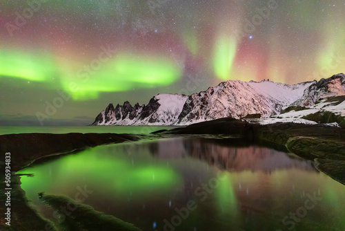 Okshornan Peaks and aurora borealis, Tungeneset at winter night, Senja Island, Norway photo