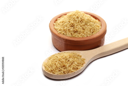  Integral uncooked rice pile in clay pot isolated on white  