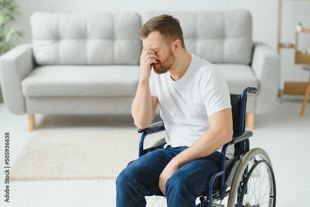 Disabled young man suffering at home Disabled young man suffering at home