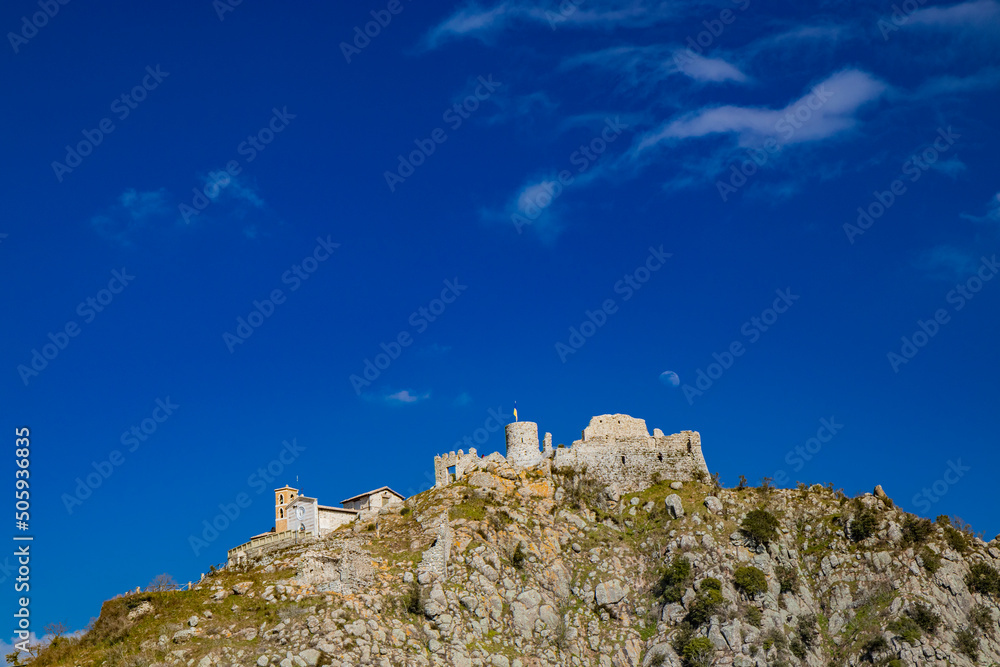 The small village of Tolfa, in Lazio. Remains of the ancient walls of the fortress on top of the cliff. Ruins of the castle. The tower where the flag of Ukraine is hoisted as a sign of solidarity.