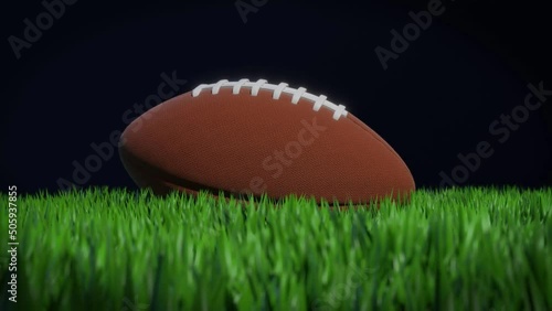 3D rendering animation of an american football ball on a grass field