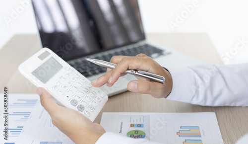 Accounting businessmen are calculating income-expenditure and analyzing real estate investment data, Dedicated to the progress and growth of the company, Financial and tax systems concept.