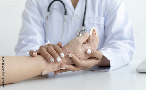 Doctor is looking at the patient's finger splint, finger straight with orthopedic device, Treatment or examination of the patient's condition...