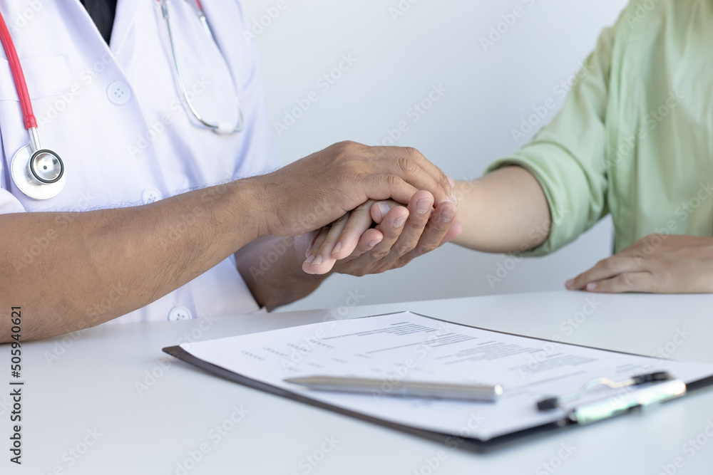 Doctors in white robes hold the hands of patients to create comfort and confidence for patients to improve health, Encouragement,Comfort and encouragement concept. Doctors in white robes hold the hands of patients to create comfort and confidence for patients to improve health, Encouragement,Comfort and encouragement concept.