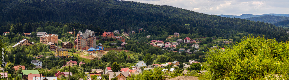 big unfinished cottages in the valley in the Ukrainian Carpathians