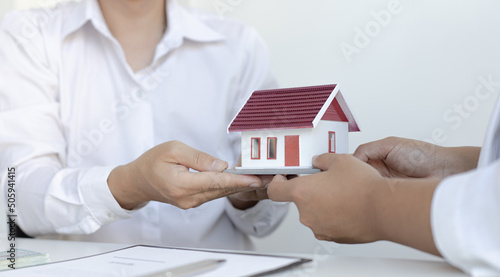 Real estate broker has given the house to customers who bought the house with insurance, Negotiating purchase-sale and investment planning concept.
