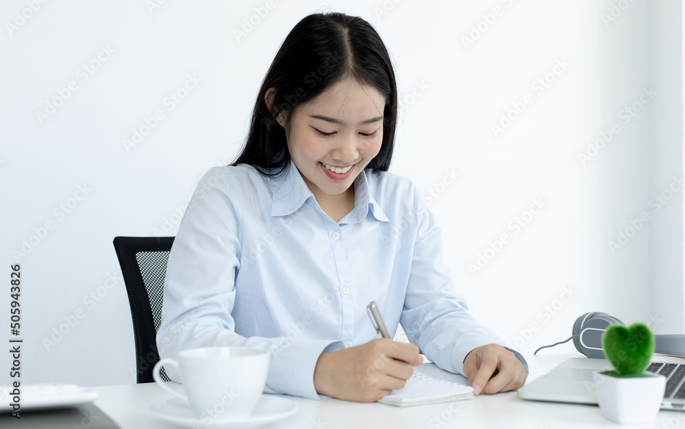 Asian female students are recording their study information in a personal notebook, Online student concept. Asian female students are recording their study information in a personal notebook, Online student concept.