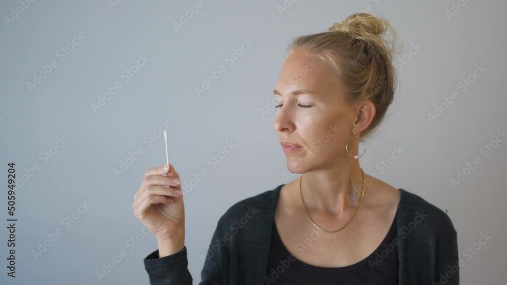 Med Close woman looking at home nasal PCR self test for covid-19 Med Close woman looking at home nasal PCR self test for covid-19