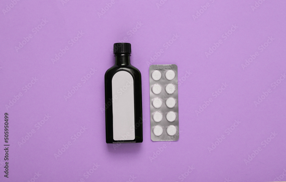 Bottle of cough syrup and blister of pills on purple background. Cough