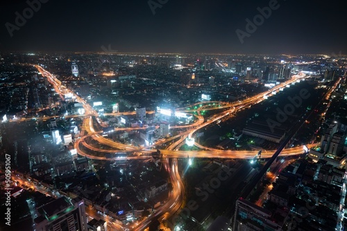 The city skyline of Bangkok Thailand and the city traffic at night