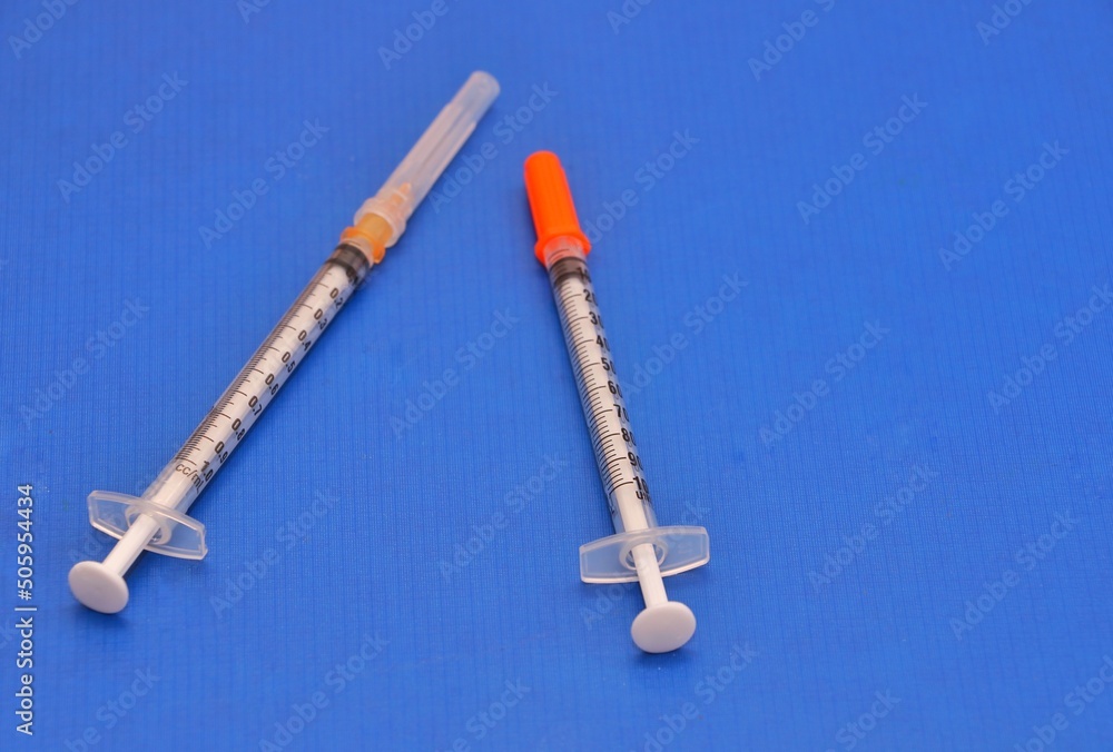 Insulin syringe and 1cc syringe used for intra-dermal injections and test doses.image isolated on a blue background Insulin syringe and 1cc syringe used for intra-dermal injections and test doses.image isolated on a blue background
