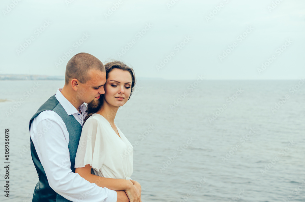 husband and wife hugging by the sea. Honeymoon.