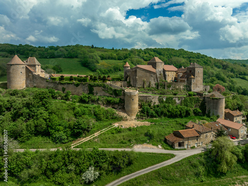 Aerial view of imposing castle of Berze Le Chatel in Burgundy with 14 towers and three enclosures in Central France dominating the valley below
