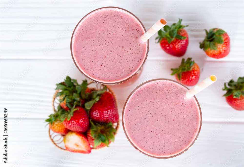 Strawberry smoothies juice beverage healthy the taste yummy In glass drink episode morning on wooden background from the top view. Strawberry smoothies juice beverage healthy the taste yummy In glass drink episode morning on wooden background from the top view.