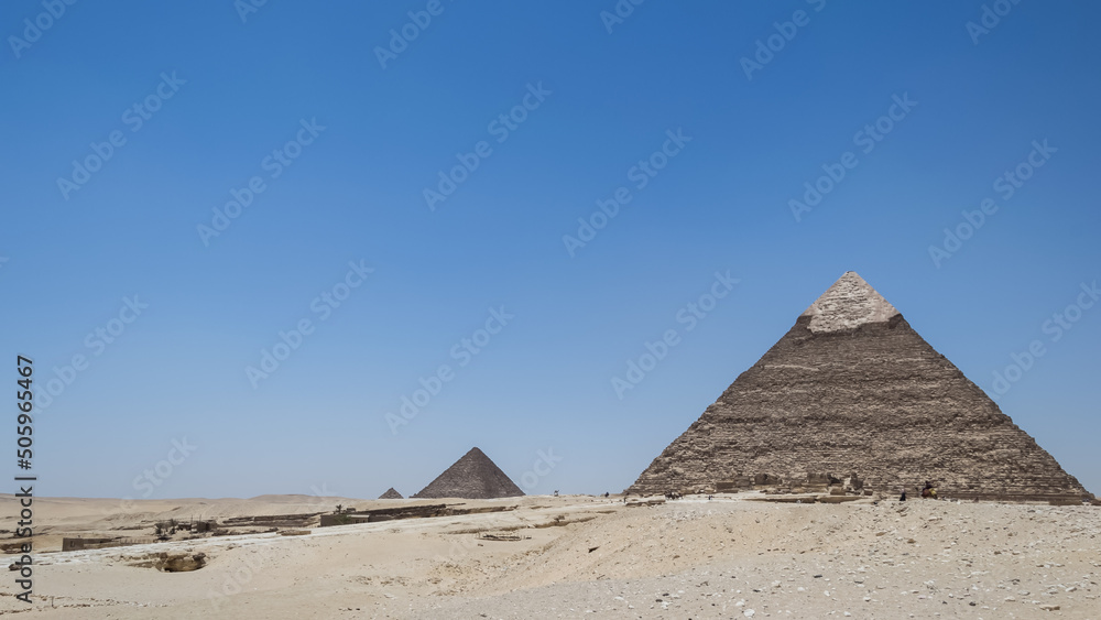 Architectural detail of the Giza pyramid complex located about 13 kilometers southwest of Cairo's city center. In the background, the Pyramid of Khafre or of Chephren