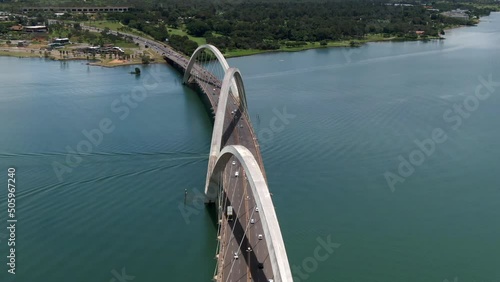 Aerial view of traffic on JK Bridge (Portuguese: Ponte JK ), a steel and concrete arch bridge across Lake Paranoa in Brasilia, Federal District, capital of Brazil. photo